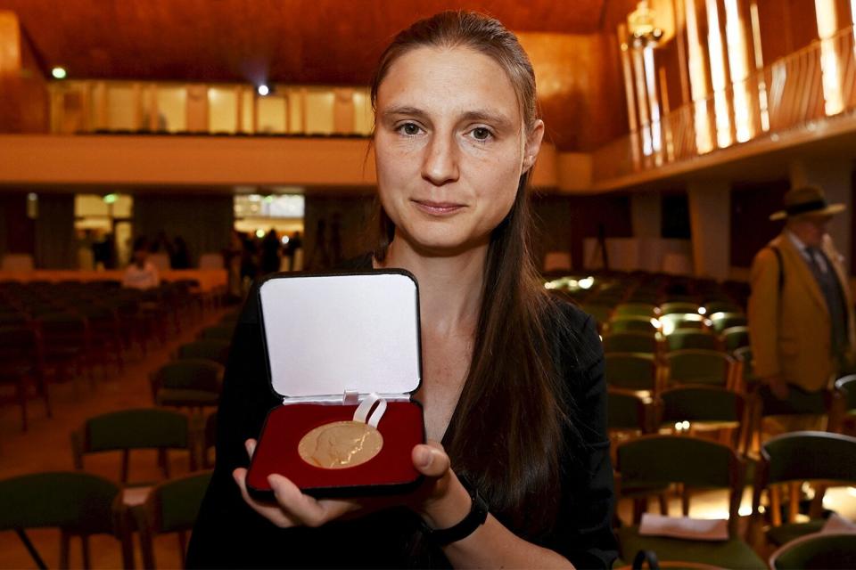 Ukraine's Maryna Viazovska presents her medal after receiving the 2022 Fields Prize for Mathematics during the International Congress of Mathematicians 2022 (ICM 2022) in Helsinki, Finland, on July 5, 2022. - The Fields medal, sometimes referred to as the Nobel Prize in mathematics, recognises "outstanding mathematical achievement" by under-40s and is awarded once every four years.