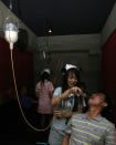 A waitress dressed in a nurse uniform serves a drink to a customer with a drip at a hospital-themed restaurant in Taipei March 18, 2009. REUTERS/Nicky Loh