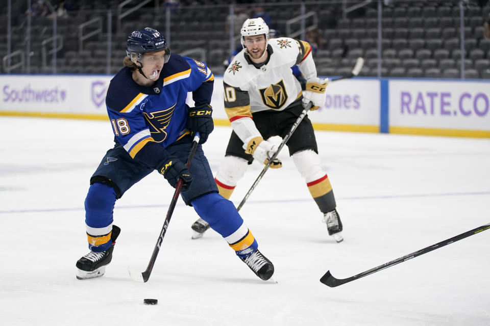 St. Louis Blues' Robert Thomas (18) looks for a shot as Vegas Golden Knights' Nicolas Roy (10) defends during the second period of an NHL hockey game Wednesday, April 7, 2021, in St. Louis. (AP Photo/Jeff Roberson)