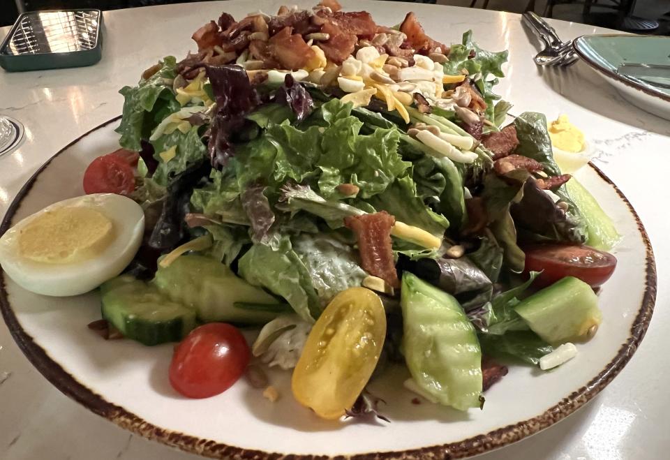 At Palm City Social, the house salad was a mass of fresh field greens topped with cucumber, tomatoes, hard boiled eggs, cheese, bacon and sunflower seeds then drizzled with buttermilk garlic dressing.