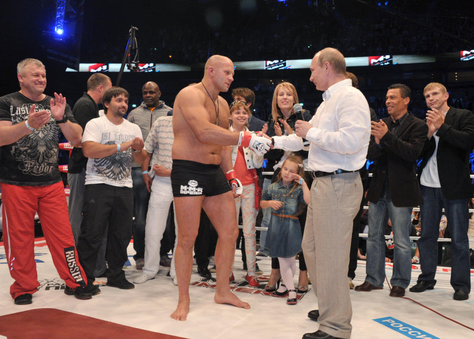 Russian President Vladimir Putin, right, congratulates heavyweight martial arts fighter Fedor Emelianenko on his victory over Brazilian Pedro Rizzo at the M-1 Global mixed martial arts tournament in St. Petersburg, Russia. Fedor Emelianenko announced his retirement after knocking out Brazilian Pedro Rizzo. (AP Photo/RIA-Novosti, Alexei Nikolsky, Presidential Press Service)