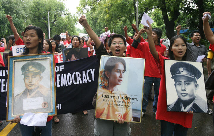 Myanmar protestors shout anti-military slogans as they display a portrait of Aung San Suu Kyi during a demonstration to mark the 20th anniversary of the 1988 pro-democracy revolutionAFP/Getty