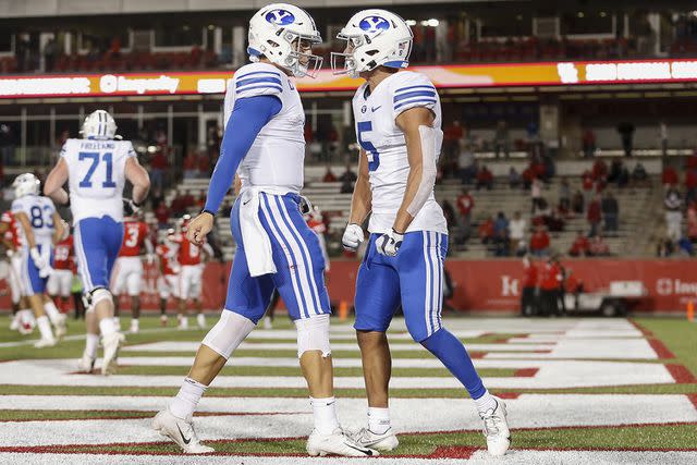 <p>Tim Warner/Getty</p> Zach Wilson and Dax Milne playing for Brigham Young University together