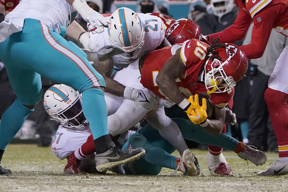 Kansas City Chiefs running back Isiah Pacheco (10) runs against Miami Dolphins safety DeShon Elliott (21) and linebacker David Long Jr. (51) during the first half of an NFL wild-card playoff football game Saturday, Jan. 13, 2024, in Kansas City, Mo. (AP Photo/Ed Zurga)