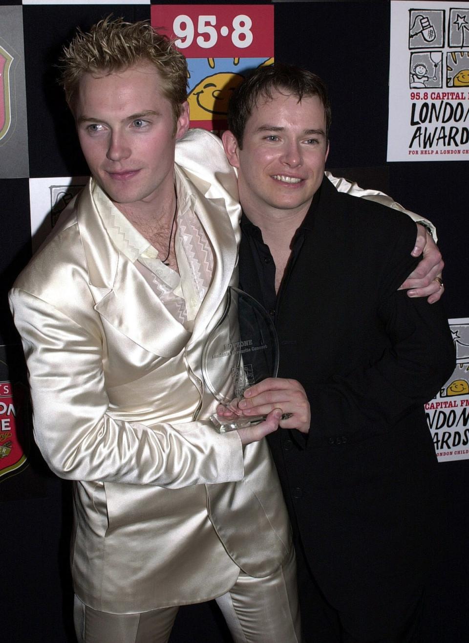 Ronan Keating and Stephen Gately of Boyzone with their award for London’s Favourite Concert at the Capital FM London Awards at the Royal Lancaster Hotel in 2000 (PA)