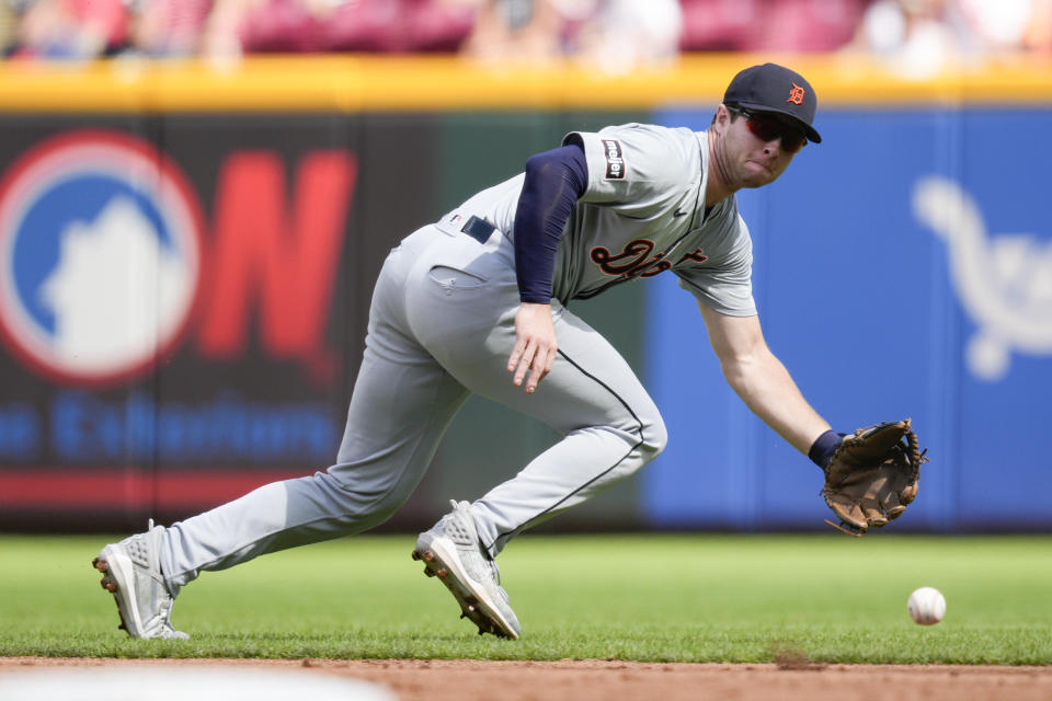 Detroit Tigers second baseman Colt Keith, center, fails to field a single hit by Cincinnati Reds' Nick Martini in the second inning of a baseball game in Cincinnati, Saturday, July 6, 2024. (AP Photo/Jeff Dean)