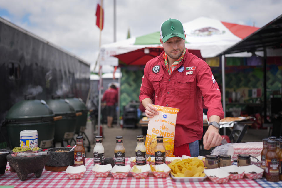 Juventino Alanis of the Sociedad Mexicano de Parrillieros team prepares food for tasting at the World Championship Barbecue Cooking Contest, Friday, May 17, 2024, in Memphis, Tenn. (AP Photo/George Walker IV)