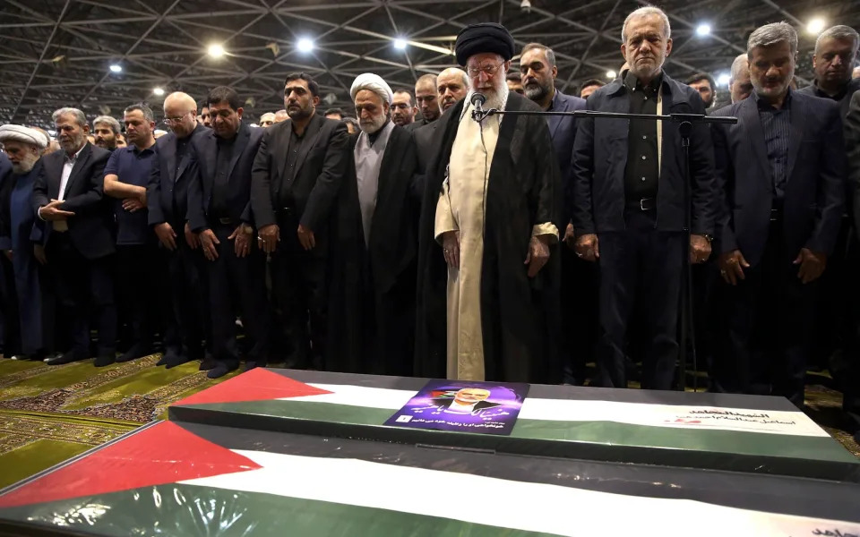 Masoud Pezeshkian (second right) prays over the coffins of Ismail Haniyeh and his bodyguard with Iran's supreme leader Ayatollah Ali Khamenei