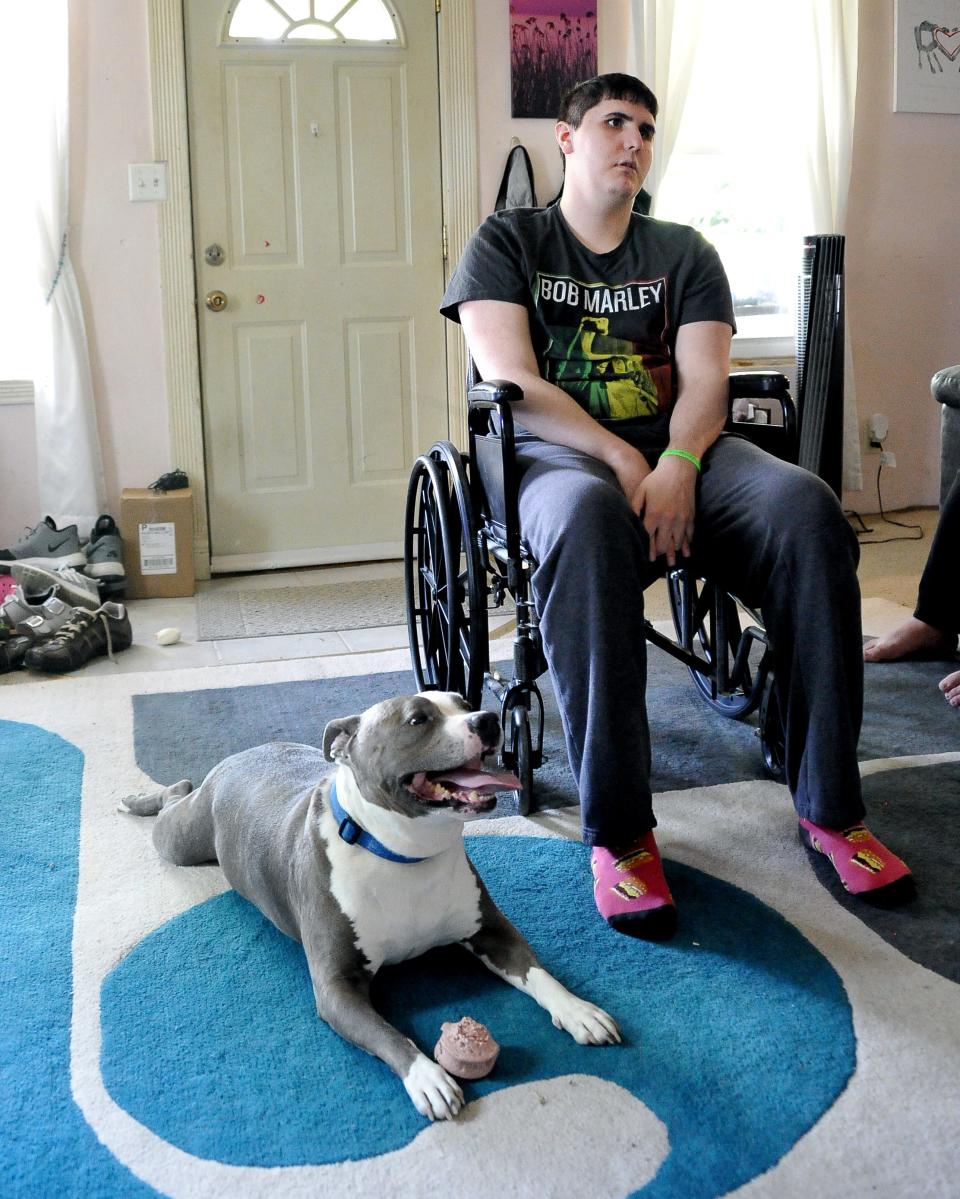 Christian Mendoza poses with the family rescue dog Bugs Bunny in his Wayne County home. The Triway Local graduate had multiple surgeries during his treatment in Akron Children's Hospital for a brain tumor for which he began having symptoms his sophomore year. He was able to rebound in time for graduation and walk in front of his peers to receive his diploma.
