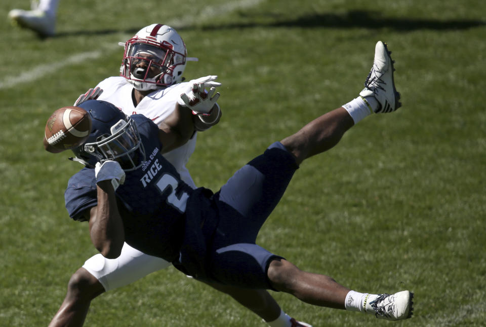 Stanford’s cornerback Terrence Alexander, back, breaks up a play by Rice’s running back Austin Walter during the opening game of the U.S. college football season in Sydney, Sunday, Aug. 27, 2017. (AP Photo/Rick Rycroft)