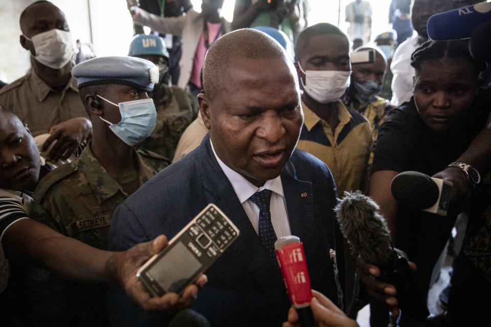 President Faustin-Archange Touadera speaks to the media after casting his vote at the Lycee Boganda polling station in the capital Bangui, Central African Republic, Sunday, Dec. 27, 2020. Touadera and his party said the vote will go ahead after government forces clashed with rebels in recent days and some opposition candidates pulled out of the race amid growing insecurity. (AP Photo)