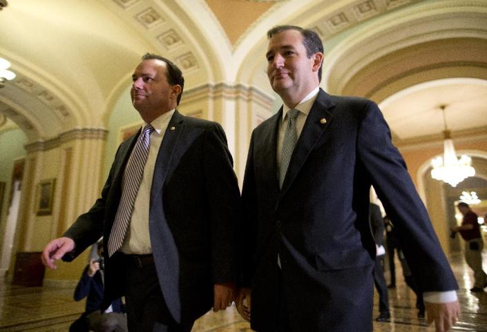 In this Oct. 16, 2013, photo, Sen. Mike Lee, R-Utah, left, and Sen. Ted Cruz, R-Texas, walk to the Senate floor to vote on a bill to raise the debt ceiling and fund the government on Capitol Hill in Washington. (Evan Vucci/AP Photo)