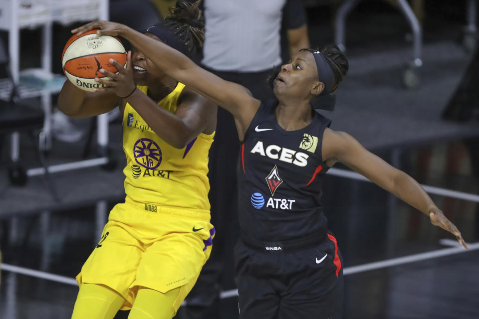 Las Vegas Aces' Sugar Rodgers, right, blocks a shot attempt by Los Angeles Sparks' Chelsea Gray during the first half of a WNBA basketball game Saturday, Sept. 12, 2020, in Bradenton, Fla. (AP Photo/Mike Carlson)