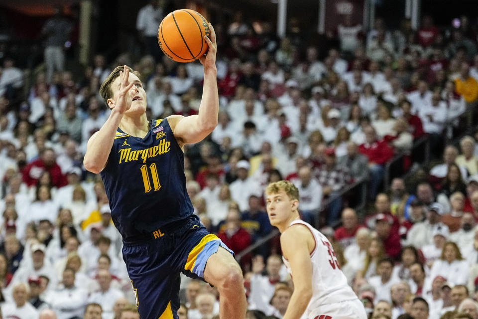 Marquette's Tyler Kolek (11) goes for a layup past Wisconsin's Markus Ilver (35) during the first half of an NCAA college basketball game, Saturday, Dec. 2, 2023, in Madison, Wis. (AP Photo/Andy Manis)