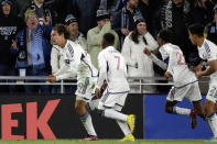 Vancouver Whitecaps forward Simon Becher, left, celebrates his goal as teammate Déiber Caicedo (7) and Ali Ahmed (22) chase him in extra minutes in the second half of an MLS soccer game against the Minnesota United Saturday, March 25, 2023, in St. Paul, Minn. (AP Photo/Andy Clayton-King)