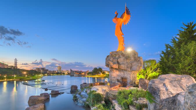 Wichita, Kansas, USA - Augusst 31, 2018: The confluence of the Arkansas and Little Arkansas River at the Keeper of the Plains near downtown Wichita at dawn.