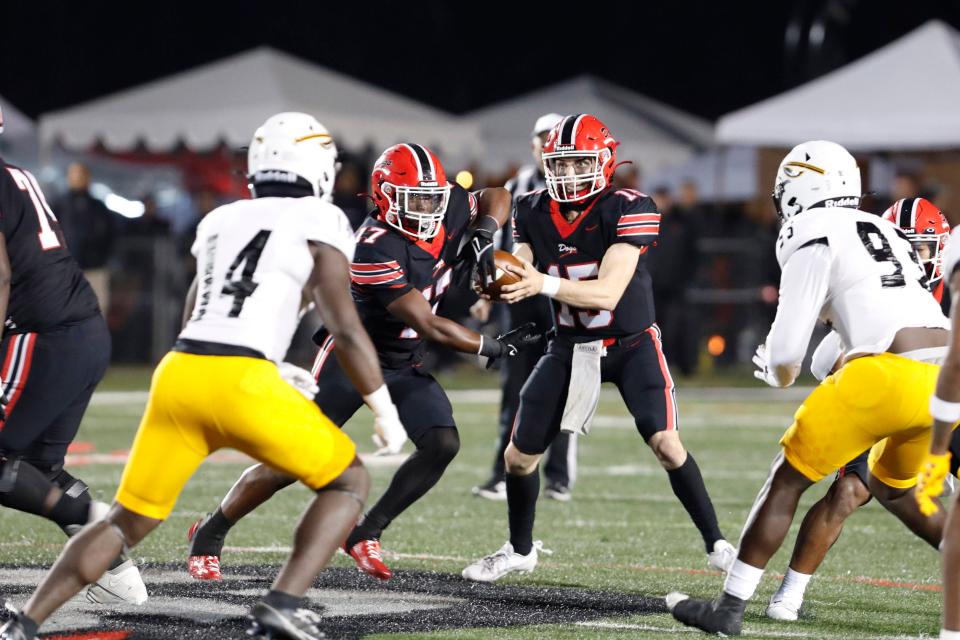 Brandon High School QB Landon Varnes (15) hands the ball off to RB Tyson Robinson (17) during their game against Oak Grove High School in the 7A tournament of the 2023 high school football championships on Saturday, Nov. 24, 2023 in Brandon, MS.