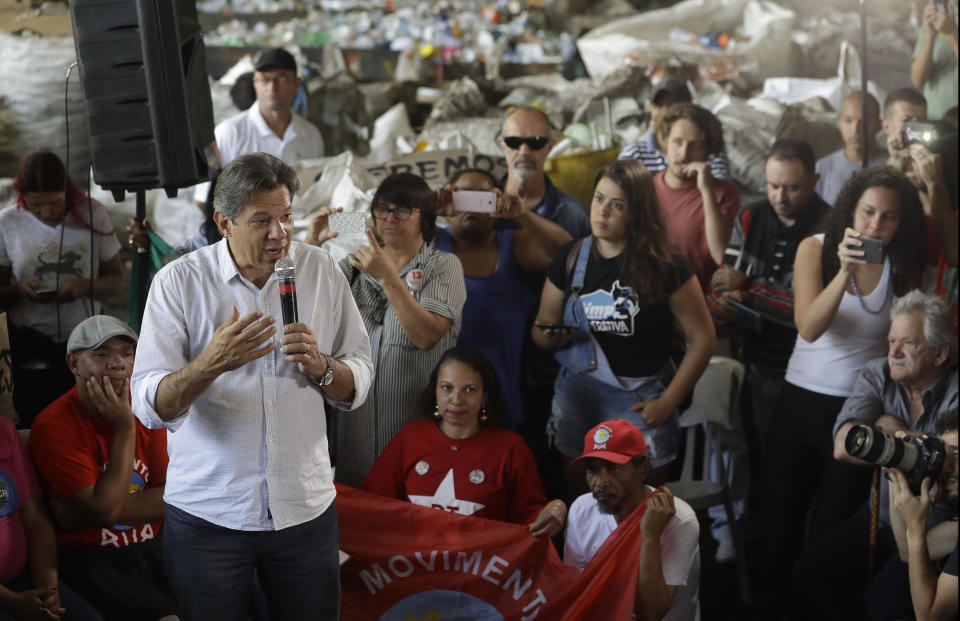 Workers' Party presidential candidate Fernando Haddad speaks to workers at a recycling cooperative, in Sao Paulo, Brazil, Monday, Oct. 22, 2018. Haddad will face Jair Bolsonaro, the far-right congressman in a presidential runoff on Sunday. (AP Photo/Andre Penner)