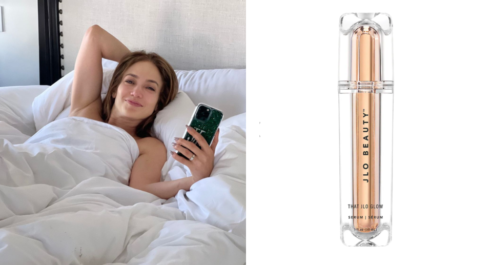 jennifer lopez laying in bed with white duvet holding phone and jlo beauty that jlow glow serum