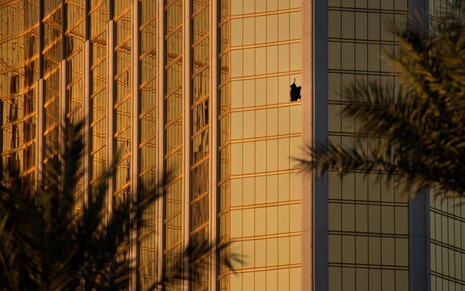 The broken window of the hotel room from which Stephen Paddock opened fire - Getty Images North America