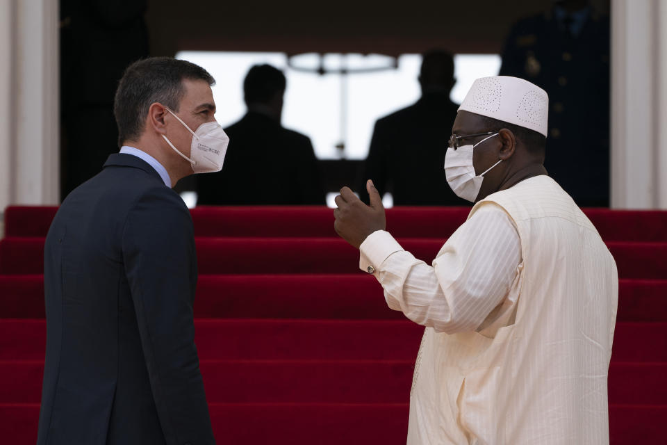 Senegal's President Macky Sall, right, speaks to Spanish Prime Minister Pedro Sanchez after a press conference at the presidential palace in Dakar, Senegal, Friday, April 9, 2021. Sanchez is on a mini-tour to Angola and Senegal that are key in the European country's new push to bolster ties with the neighboring continent and mitigate the migration flows that many fear could increase as a consequence of the coronavirus pandemic. (AP Photo/Leo Correa)