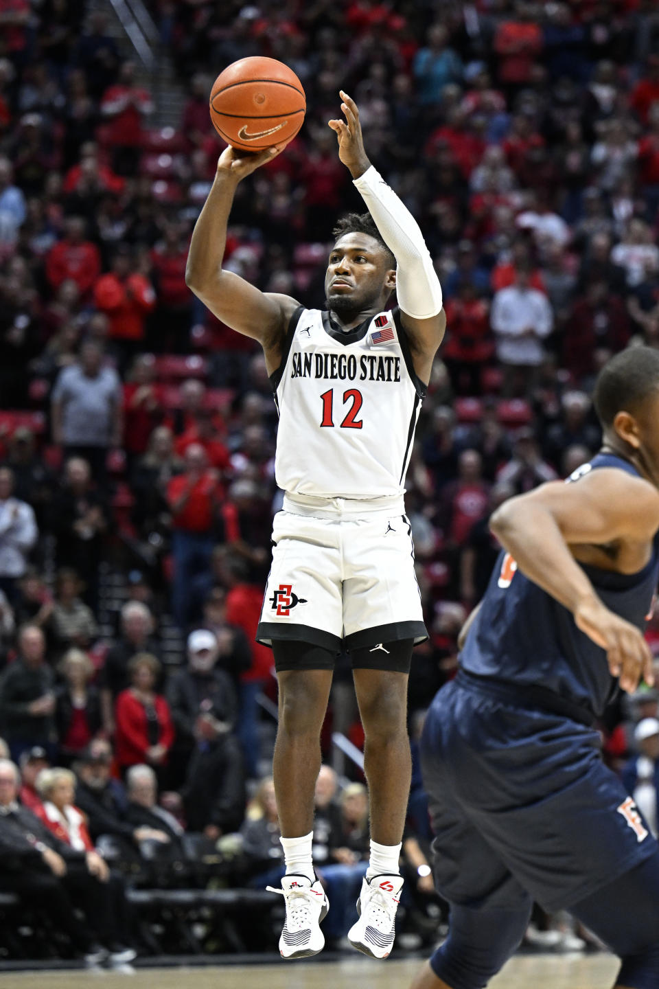 San Diego State guard Darrion Trammell (12) shoots during the first half of an NCAA college basketball game against Cal State Fullerton Monday, Nov. 7, 2022, in San Diego. (AP Photo/Denis Poroy)