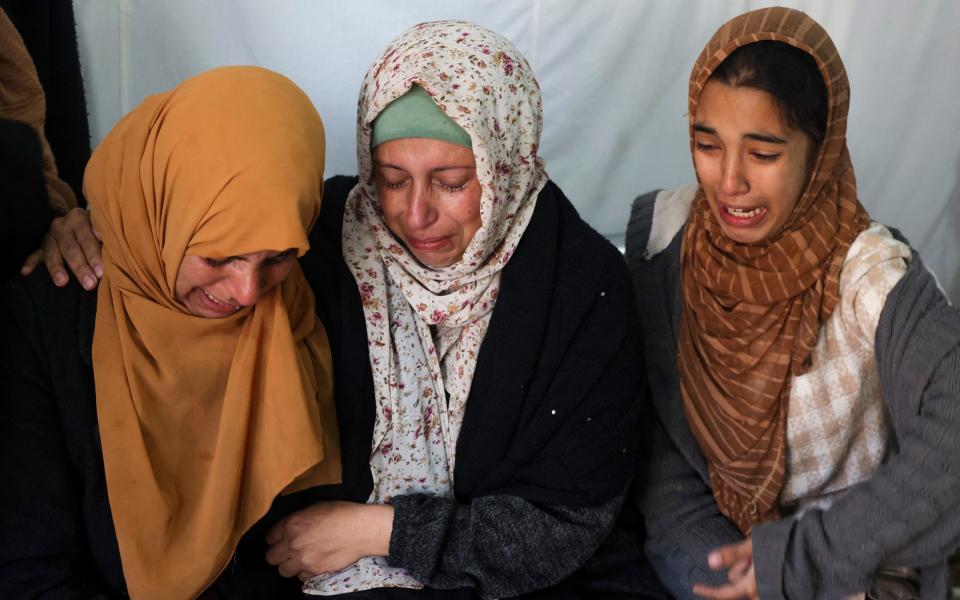 Women mourn loved ones killed during Israeli bombardment at Al-Najar hospital in Rafah, on the southern Gaza Strip