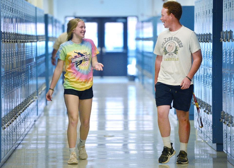 Clear Spring High School students, Emerson Moats, left, 15, and Hayden Muir, 17, walk in the hallway during the last day of the school year Tuesday. 