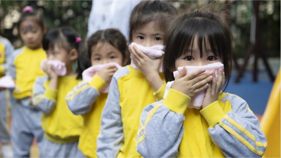 Kindergarten children take part in a fire evacuation drill on the first day of a new semester on February 22, 2021 in Guangzhou, Guangdong Province of China.