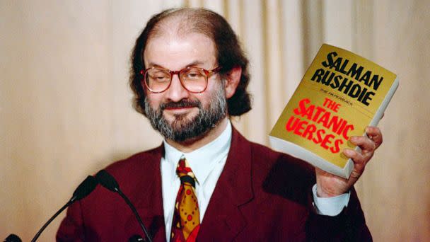 PHOTO: Salman Rushdie holds up a copy of his book 'The Satanic Verses' at Freedom Forum in Arlington, Va., March 1992.  (Ron Edmonds/AP)