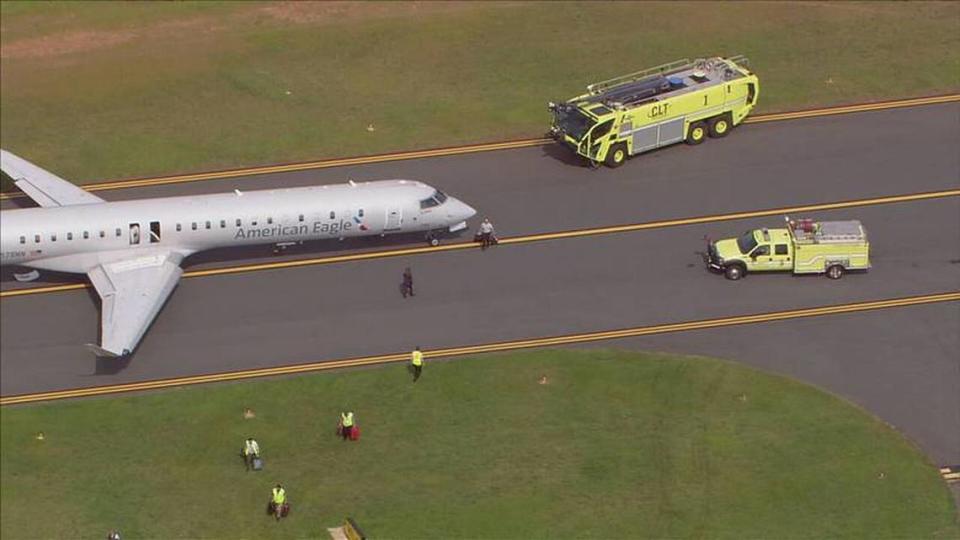 Safety crews surround an American Eagle jet on the tarmac at Charlotte Douglas International Airport on Monday, June 27, 2022. A report for a possible odor in the jet cabin forced the Florida-bound flight to be stopped on the taxiway.