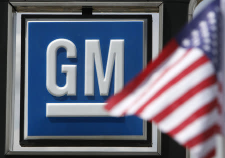 The U.S. flag flies at the Burt GM auto dealer in Denver June 1, 2009. REUTERS/Rick Wilking/Files