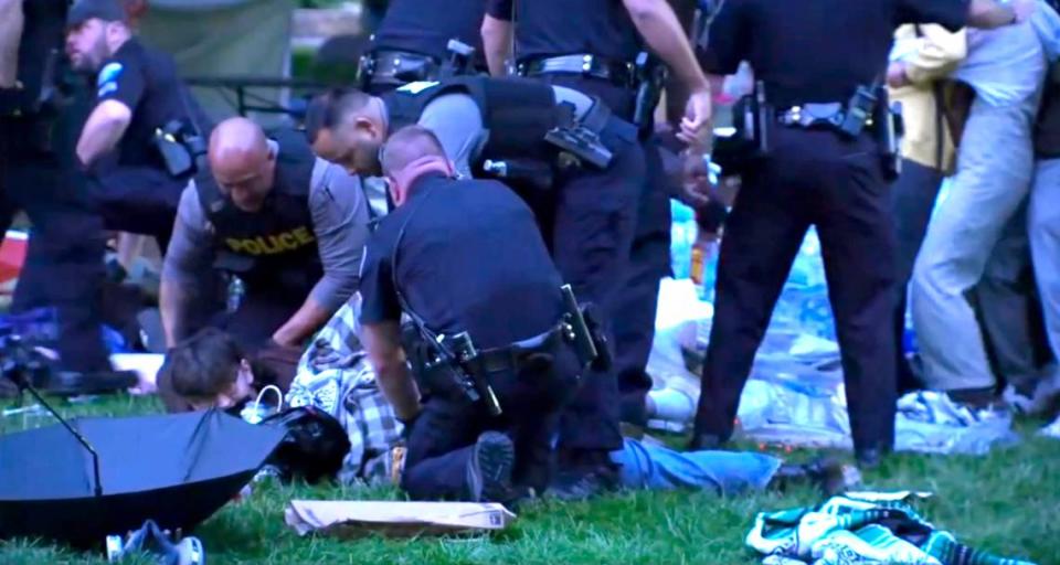 Police arrest protesters early Tuesday morning on the UNC campus in Chapel Hill.
