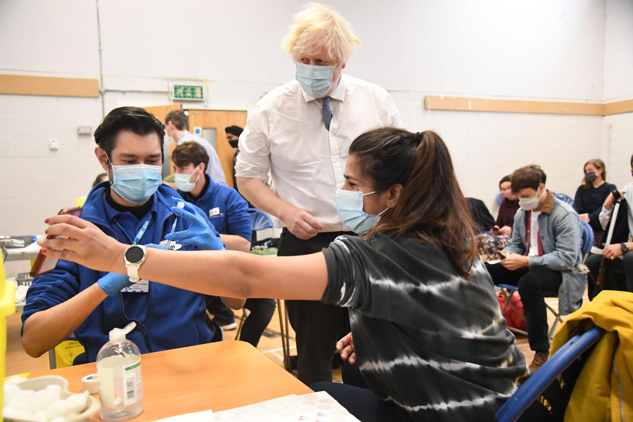 LONDON, ENGLAND - DECEMBER 13: British Prime Minister Boris Johnson visits Stow Health Vaccination centre in Westminster on December 13, 2021 in London, England. Last night, the government announced it was accelerating its Covid-19 booster programme due to concerns about the Omicron variant. The UK now intends to offer every adult a booster jab before the end of the year. (Photo by Jeremy Selwyn - WPA Pool/Getty Images)