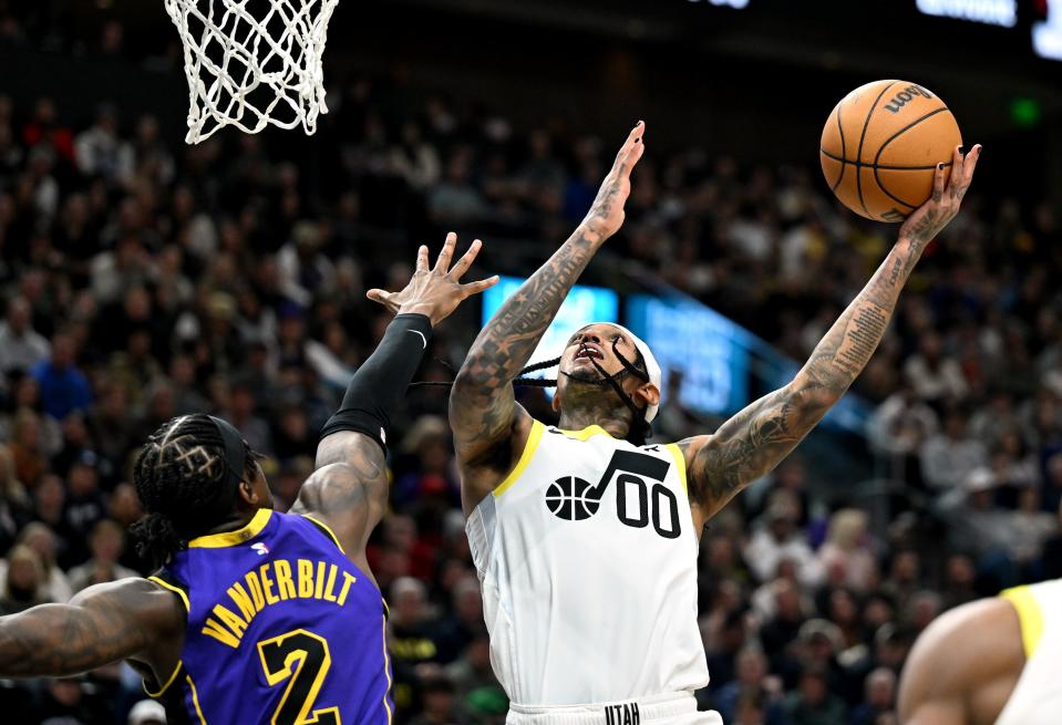 Utah Jazz guard Jordan Clarkson (00) flips up a shot over Los Angeles Lakers forward <a class="link " href="https://sports.yahoo.com/nba/players/6052" data-i13n="sec:content-canvas;subsec:anchor_text;elm:context_link" data-ylk="slk:Jarred Vanderbilt;sec:content-canvas;subsec:anchor_text;elm:context_link;itc:0">Jarred Vanderbilt</a> (2) as Utah and Los Angeles play at the Delta Center in Salt Lake City on Saturday, Jan. 13, 2024. | Scott G Winterton, Deseret News