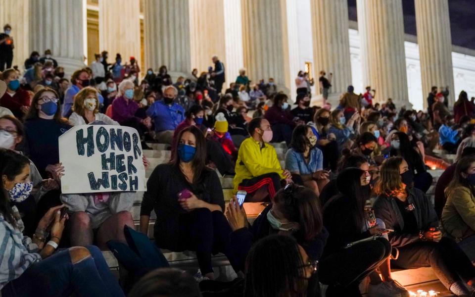 People gathered outside the Supreme Court on Friday night after her death was announced - AP