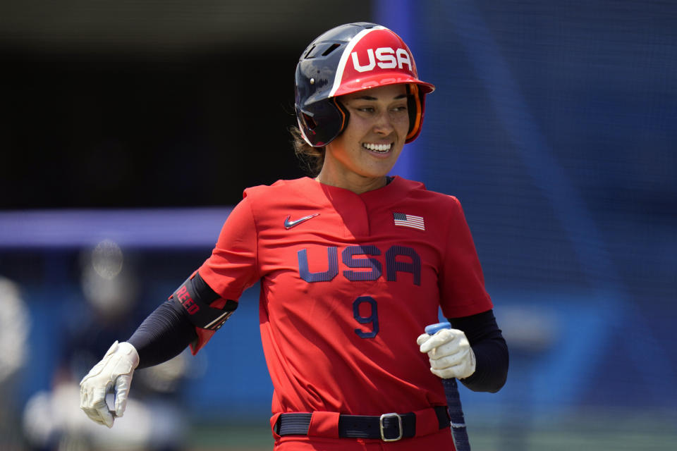 FILE - United States' Janie Reed smiles during a softball game against Italy at the Fukushima Azuma Baseball Stadium at the 2020 Summer Olympics in Fukushima, Japan, in this Wednesday, July 21, 2021, file photo. Getting ready to reach softball's peak and make her Olympic debut for the United States, Janie Reed was on a training field at Marine Corps Air Station Iwakuni, in western Japan. Across the Pacific Ocean, 7,452 miles away, another important family first was unfolding in Miami: husband Jake Reed was about to walk onto a major league mound for the first time. (AP Photo/Jae C. Hong, File)