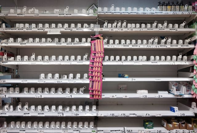 Empty shelves where hand sanitiser is usually stocked inside a London supermarket 