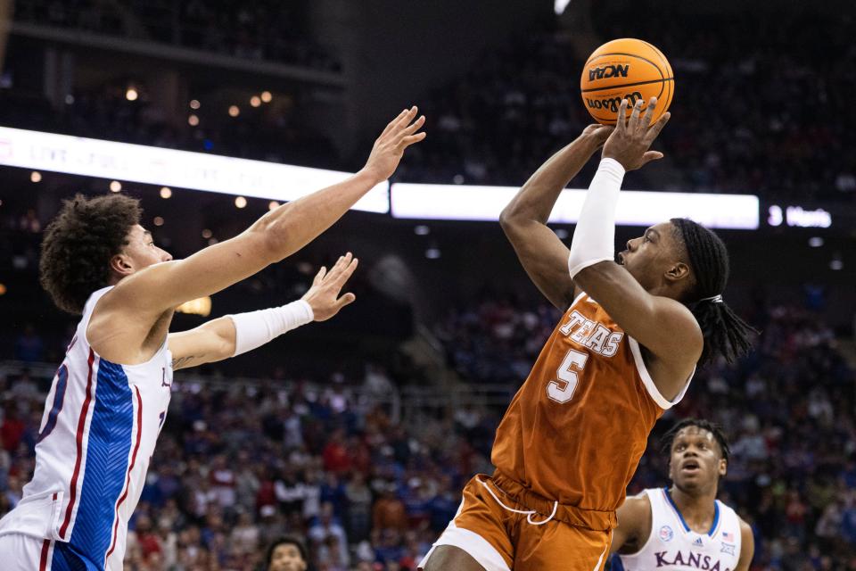 Texas guard Marcus Carr shoots over Kansas forward Jalen Wilson during Saturday's Big 12 championship game. Carr broke out of his recent scoring slump, finishing with 17 points.