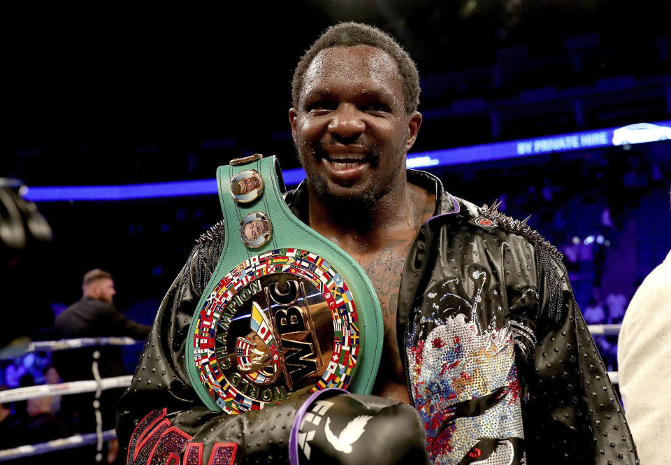 Dillian Whyte celebrates his victory after defeating Oscar Rivas on points in the WBC interim Heavyweight title fight at the O2 Arena, in London, Saturday, July 20, 2019. (Bradley Collyer/PA via AP)