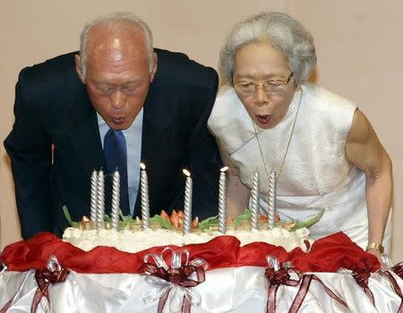 Lee Kuan Yew, architect of modern Singapore, and his wife Kwa Geok Choo (R) blow out candles on his birthday cake as he celebrates his 80th birthday in Singapore, September 16, 2003. REUTERS/David Loh/Files