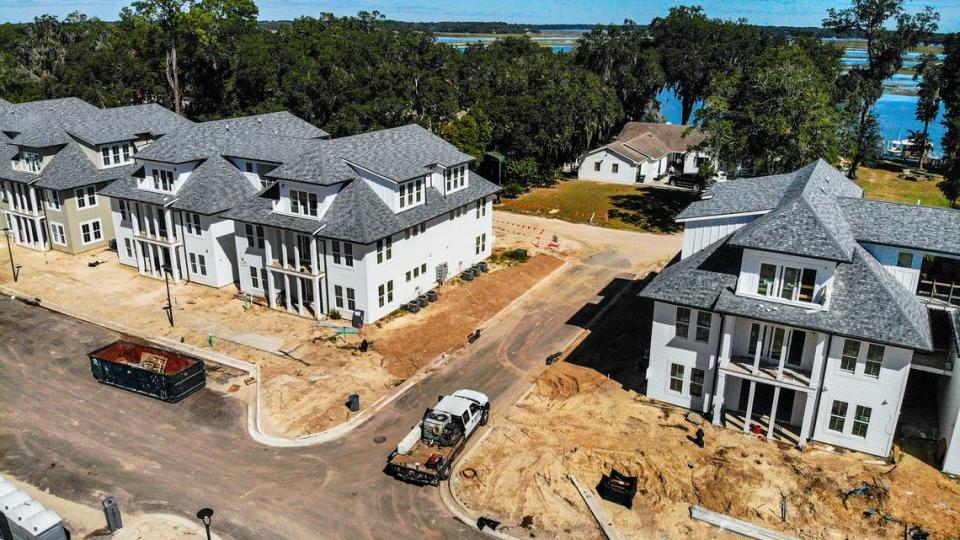 The Gecy home, located in Beaufort County is seen tucked in among live oaks with Spanish Moss in the Belleview Bluff Subdivision, comprised of seven lots that face Battery Creek as seen on Thursday, October. 19, 2023. In the foreground are some of the 12, three-story buildings known as Integra Wharf at Battery Creek being constructed in the Town of Port Royal.