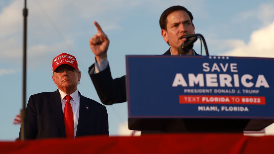 Former President Donald Trump listens as Sen. Marco Rubio speaks during a rally at the Miami-Dade County Fair and Exposition on November 6, 2022 in Miami, Florida. - Joe Raedle/Getty Images