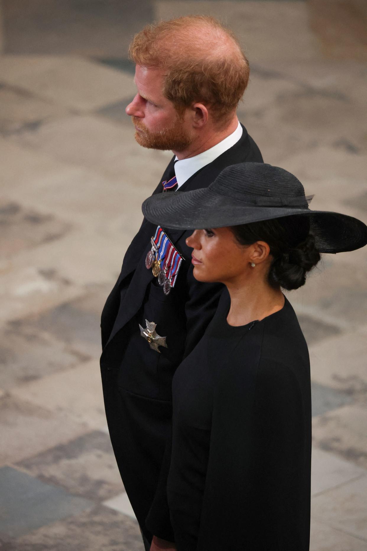 Britain's Prince Harry, Duke of Sussex (L) and Meghan, Duchess of Sussex (R) attend the State Funeral Service for Britain's Queen Elizabeth II at Westminster Abbey in London on September 19, 2022. (Photo by PHIL NOBLE / POOL / AFP) (Photo by PHIL NOBLE/POOL/AFP via Getty Images)