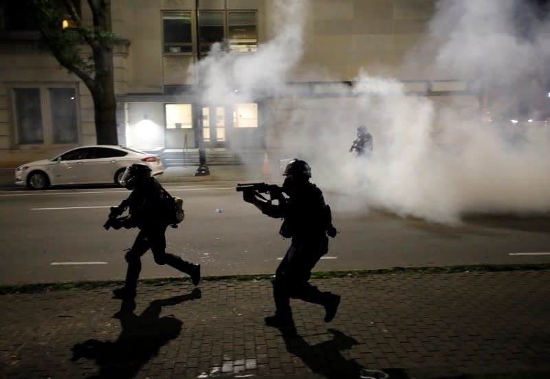 Riot police run at protesters while firing tear gas during nationwide unrest following the death in Minneapolis police custody of George Floyd, in Raleigh