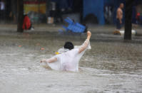 <p>A pedestrian wades through waist-high floodwaters on a street amid heavy rainfall as Typhoon Mangkhut hits Zhongshan, Guangdong province, China on Sept. 16, 2018.<br>(Photo by Reuters) </p>