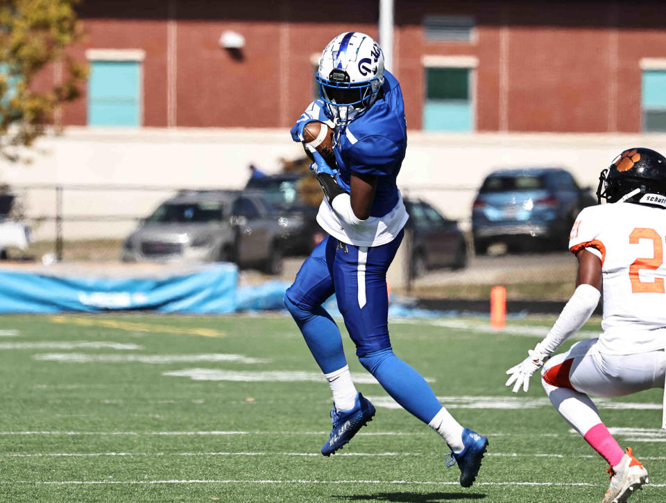 Woodward wide receiver Donte Ferrell (5) catches a pass in front of Withrow defensive back Terhyon Nichols (21) during their football game Saturday, Oct. 8, 2022.