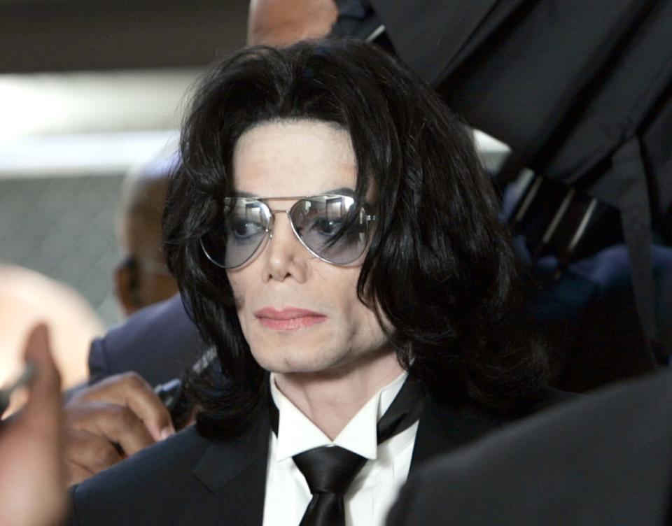 SANTA MARIA, CA – JUNE 13: Michael Jackson prepares to enter the Santa Barbara County Superior Court to hear the verdict read in his child molestation case June 13, 2005 in Santa Maria, California. After seven days of deliberation the jury has reached a not guilty verdict on all 10 counts in the trial against Michael Jackson. Jackson was charged in a 10-count indictment with molesting a boy, plying him with liquor and conspiring to commit child abduction, false imprisonment and extortion. He pleaded innocent. (Photo by Kevork Djansezian-Pool/Getty Images)