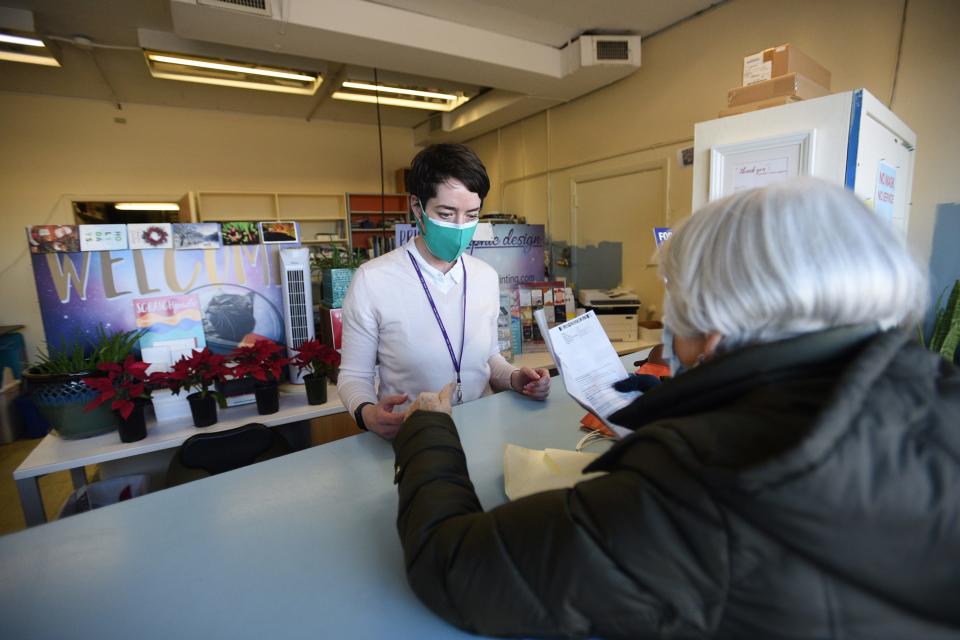 Erin Bracken, owner and operator of O'Shea Printing & Graphics in Hackensack, takes care of her customer Mary McDonnell of Teaneck at her store on Tuesday February 15,2022.