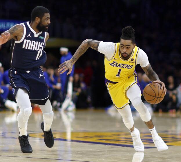 Los Angeles, CA - January 17: Lakers point guard D'Angelo Russell, #1, right, drives to the hoop as Mavericks point guard Kyrie Irving, #11, defends in the first half at Crypto.com Arena in Los Angeles Wednesday, Jan. 17, 2024. Lakers win 110-127. (Allen J. Schaben / Los Angeles Times)